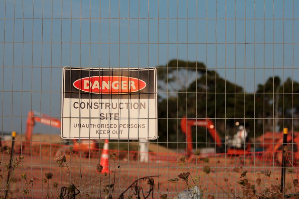Danger construction site warning sign representing risks in property auctions