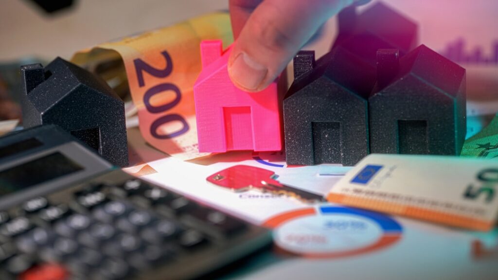 Real estate investment with house models and euro banknotes representing financial analysis of property costs