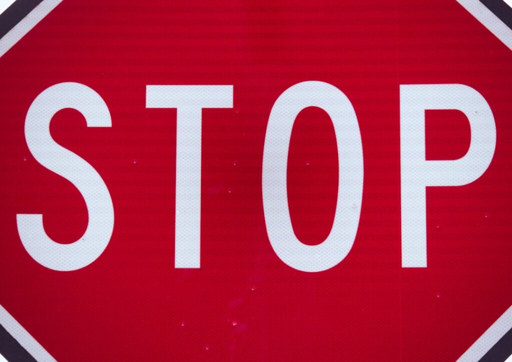 Red stop sign representing warning and caution to avoid common contract mistakes