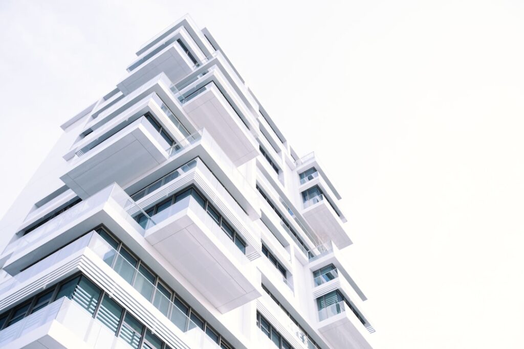 Modern luxury apartment building with glass facade, representing high-value condominium properties in Barra da Tijuca