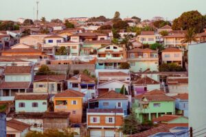 Colorful Brazilian neighborhood with diverse housing types representing mixed urban development that housing lawyers help regularize