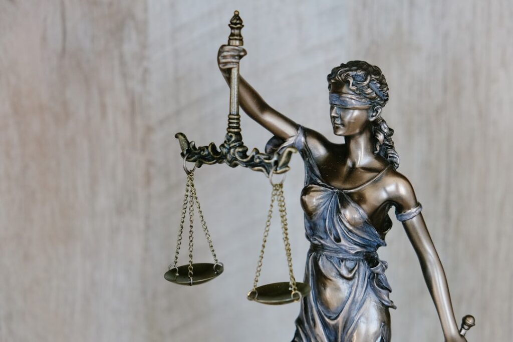 Lady Justice statue holding scales representing the balance and comparison between legal specializations