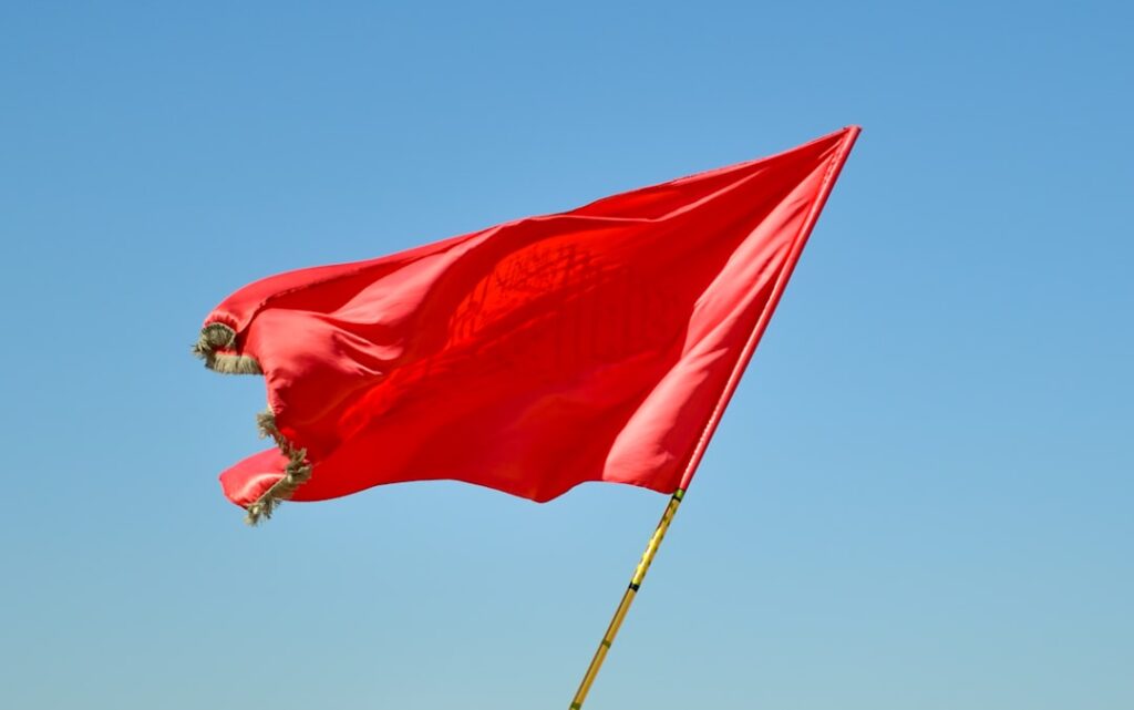 Red flag warning symbol representing contract red flags to avoid