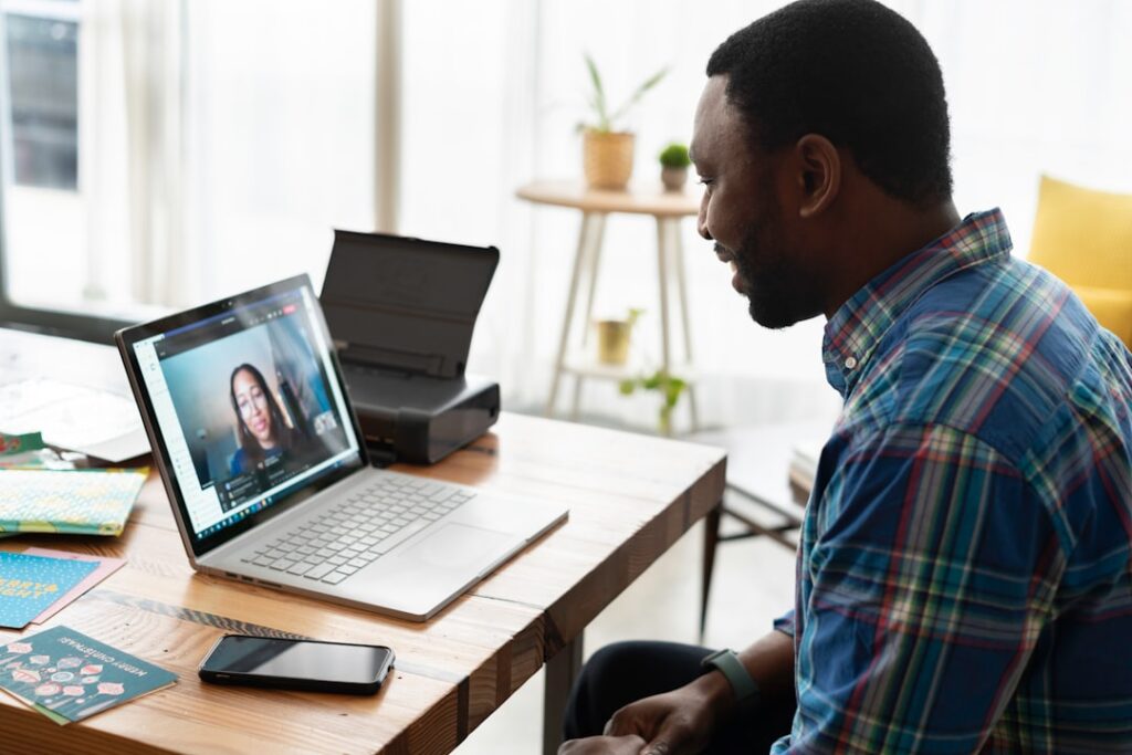 Professional working on a video call consultation from office with laptop