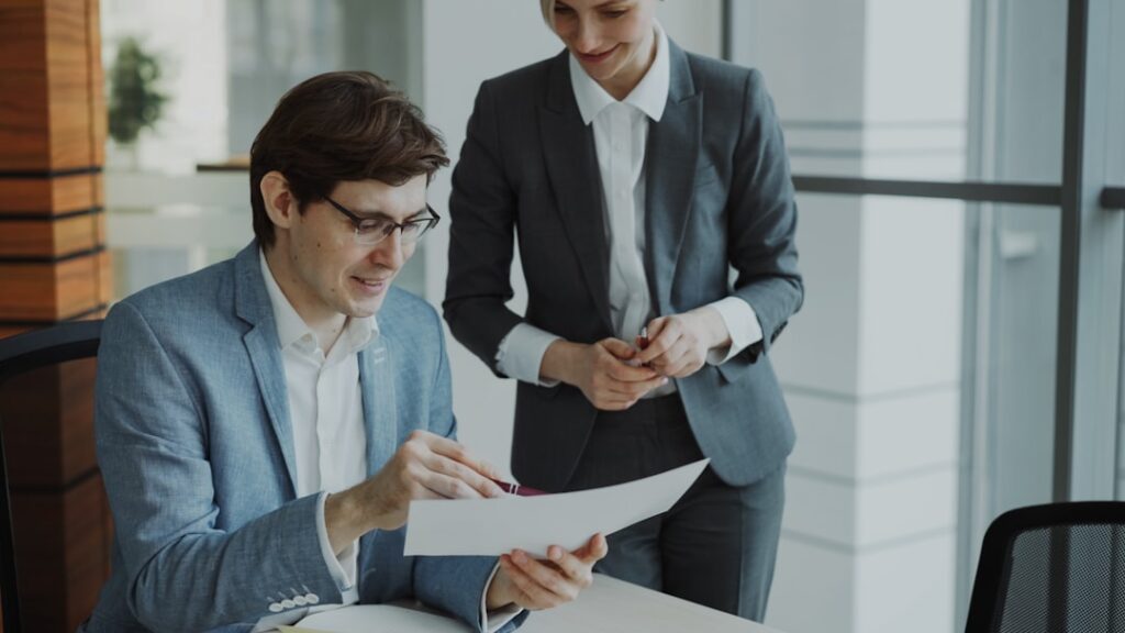 Professional consultation with lawyer and client discussing documents in modern office