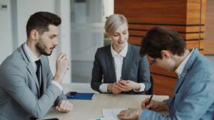 Professional lawyers in consultation meeting discussing legal documents for real estate services