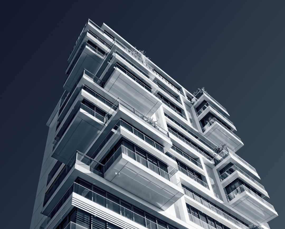 Modern luxury condominium building representing high-end real estate requiring due diligence. Photo by Unsplash