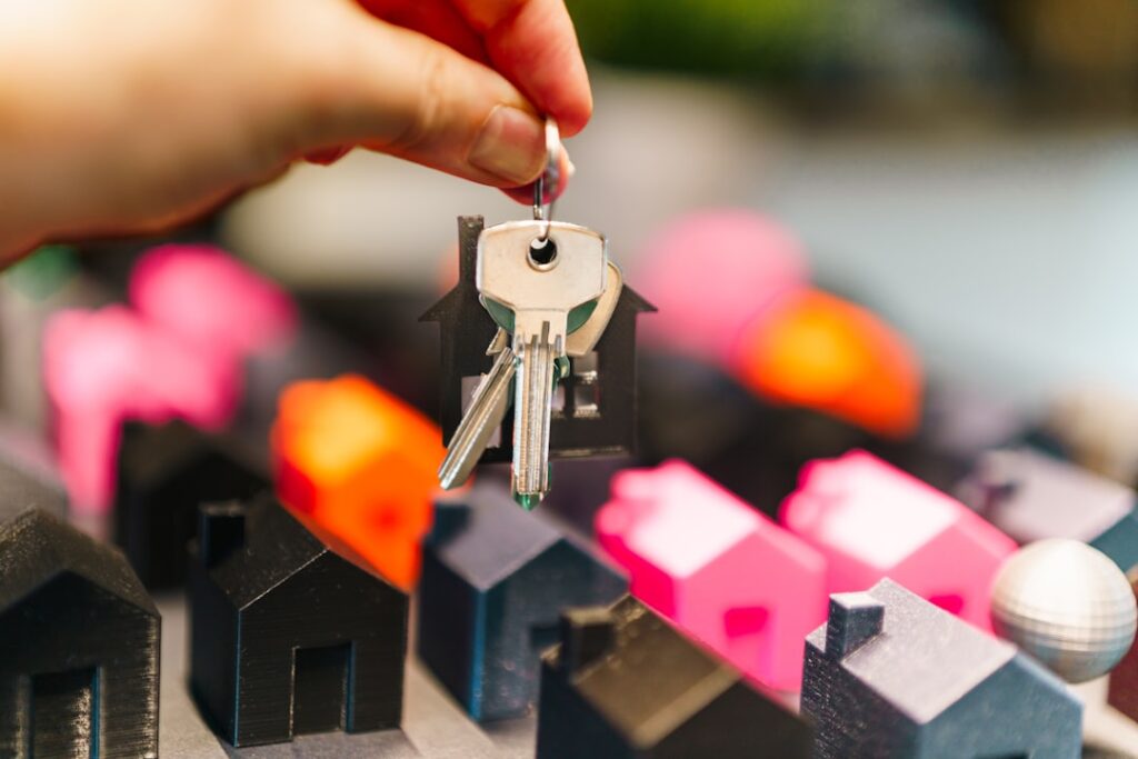 House keys and miniature model houses representing real estate law and property transactions