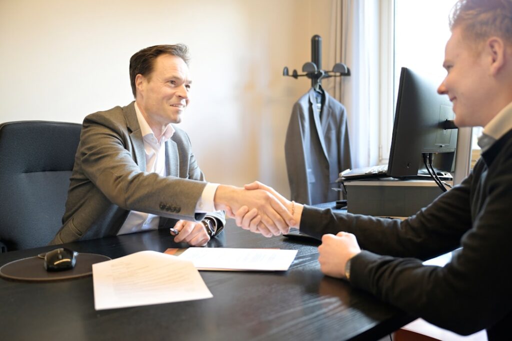 Professional lawyer consultation meeting with handshake in modern office - Photo by Md Ishak Rahman on Unsplash